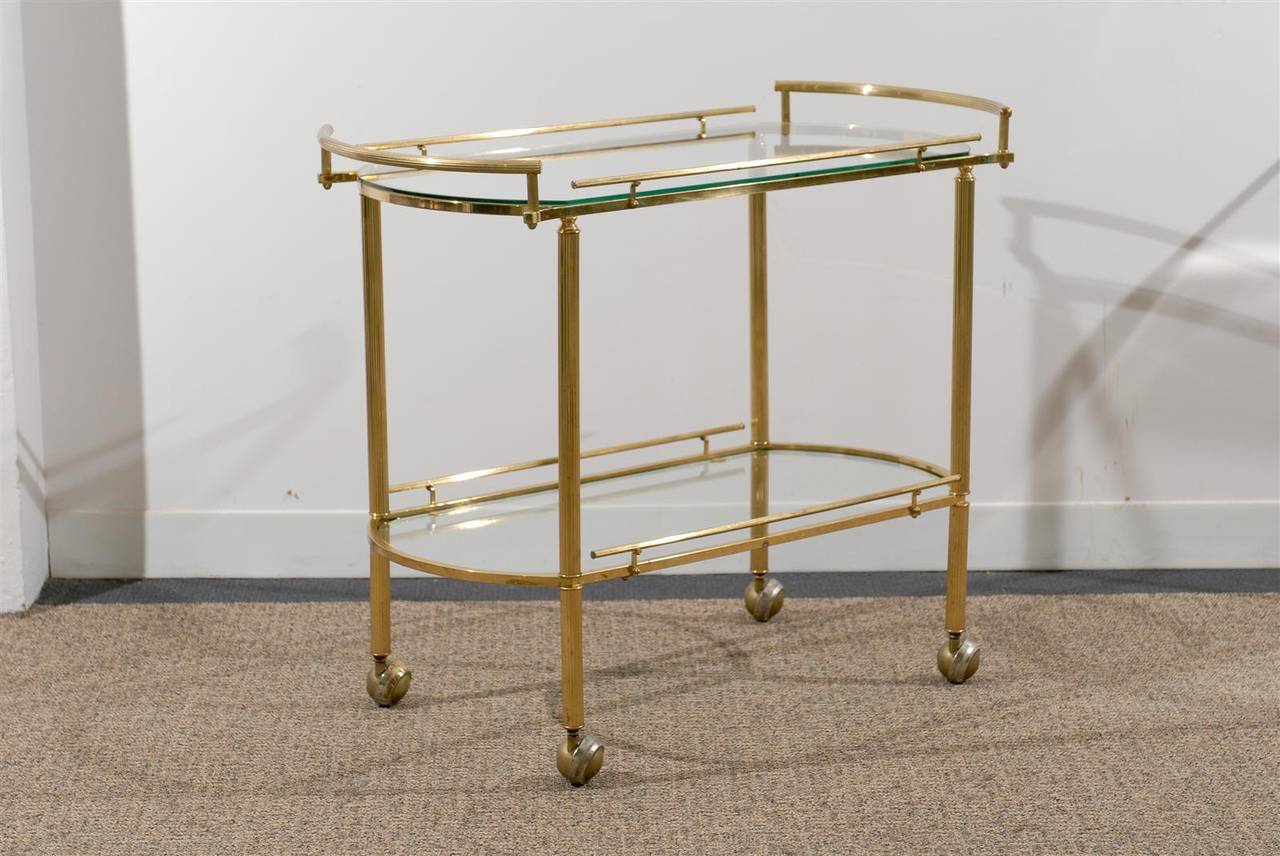 Mid-Century Modern fluted brass and glass tea cart or bar on wheels, 
circa 1978.