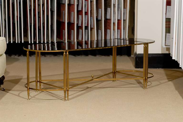 Directoire Style coffee table. Top is smoked glass with  mirrored border on beautiful brass frame.  Made in three sections attributed the Jansen Style.
