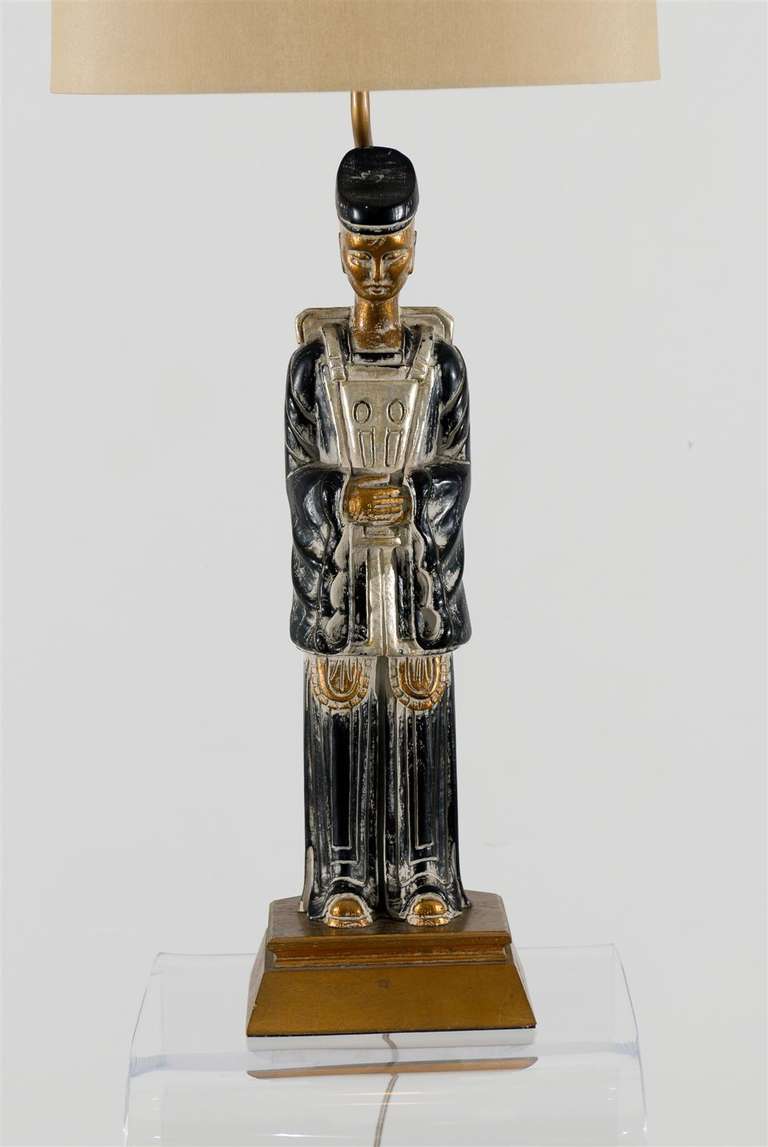 A Gorgeous pair of carved wood Asian figure lamps, circa 1950.  Cerused ebony with gold and silver leaf accents.  Highly Dramatic pieces which are also useful when unifying both gold and silver tones in a room.  Exquisite Jewelry !  Excellent