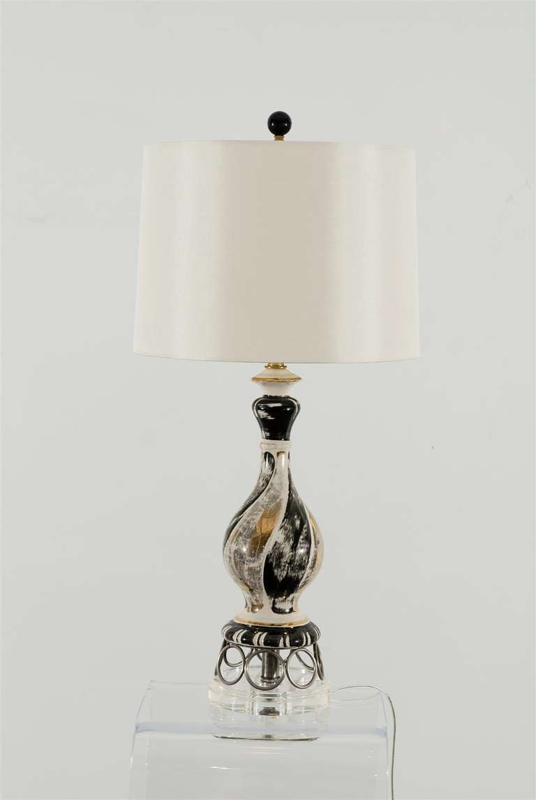 A Fabulous pair of vintage ceramic lamps with black, silver and gold highlights. While the pieces are unmarked, they are reminiscent of Italian ceramic production, circa 1960.  Exceptional Jewelry!  Excellent Restored Condition, rewired with clear