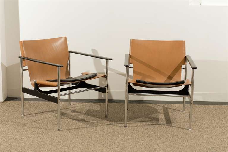 An Exceptional pair of the desirable model 657 leather sling lounge/club chair by Charles Pollock for Knoll, circa 1970's.  Tan leather with black leather cushion and accents.  Excellent Vintage Condition.  Retains the Maker mark.  The price listed