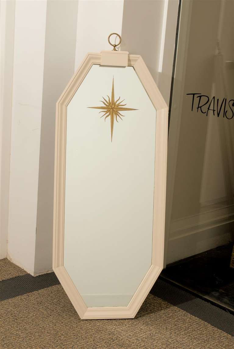Pair of chic mid century style painted mirrors with reverse etched gold starburst finished with brass ring finial on top