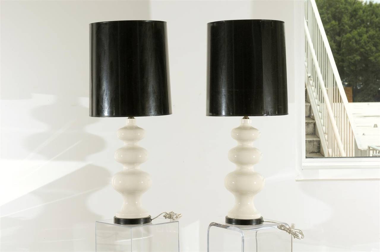 Pair of White Modern Porcelain Lamps Origin Italy Circa 1970 With original Black Paper Shades on Black Bases Rewired with Clear Cords
Height to top of shade 39