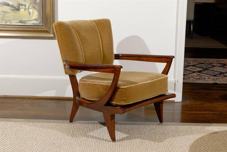 An Absolutely Exquisite pair of walnut lounge chairs by Etienne Henri Martin, circa 1940.  Extremely Comfortable. Elegant vintage Mohair fabric complement the pieces. Upholstery is in near Pristine condition and is ready to enjoy.  Stunning ! 