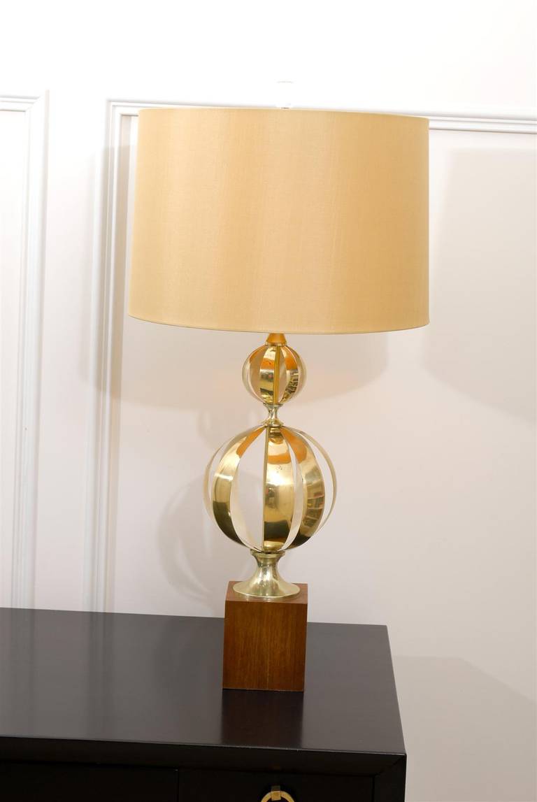 An absolutely jaw-dropping pair of vintage lamps. Individual cut brass pieces (brass on one side, cream enamel on the other) tension loaded on a brass rod, creating two stacked spheres. Mounted on a handsome Walnut plinth. The exceptional