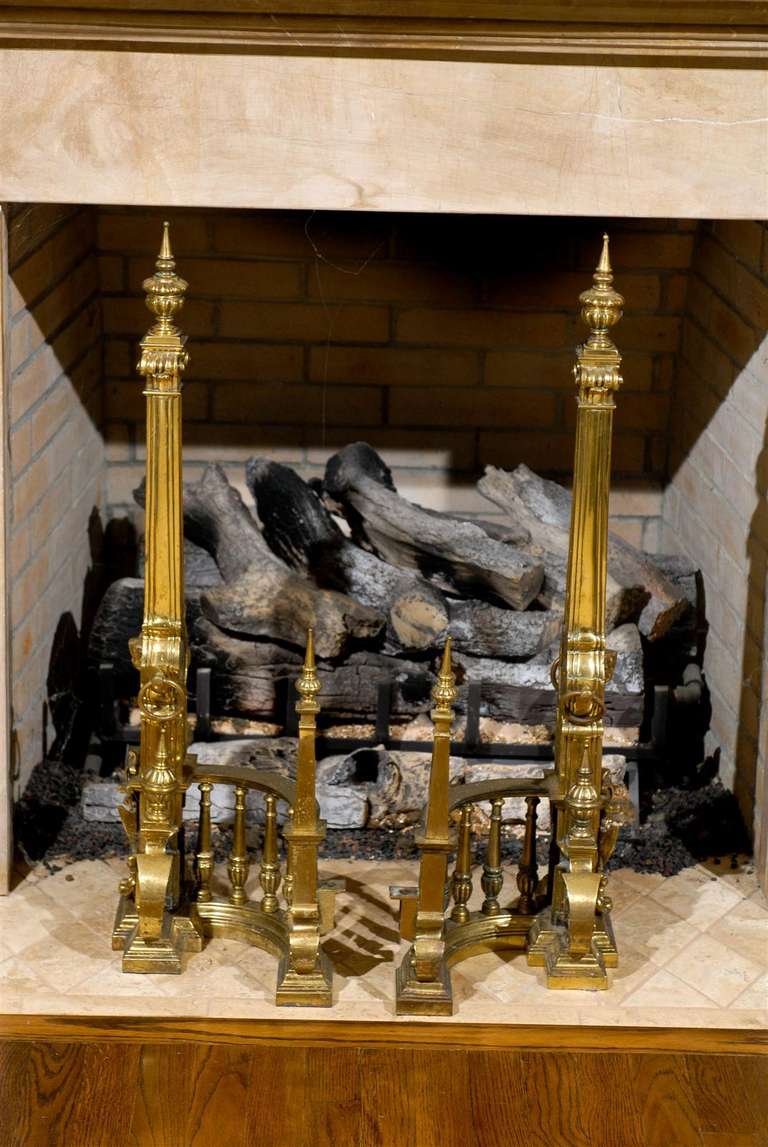 An absolutely stunning pair of high style andirons in bronze. Large scale with  fabulous detail. These pieces will make even the most ordinary of fireplaces an architectural focal point. Excellent vintage condition. The price noted is for the pair.