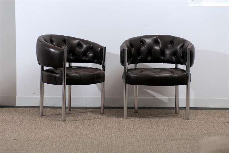 A Stunning pair of tufted leather and chrome arm chairs. Very heavy and well made. While the chairs are unmarked, they are reminiscent of Harvey Probber production of the 1970's. Extremely Sophisticated ! Excellent Vintage Condition, in the original