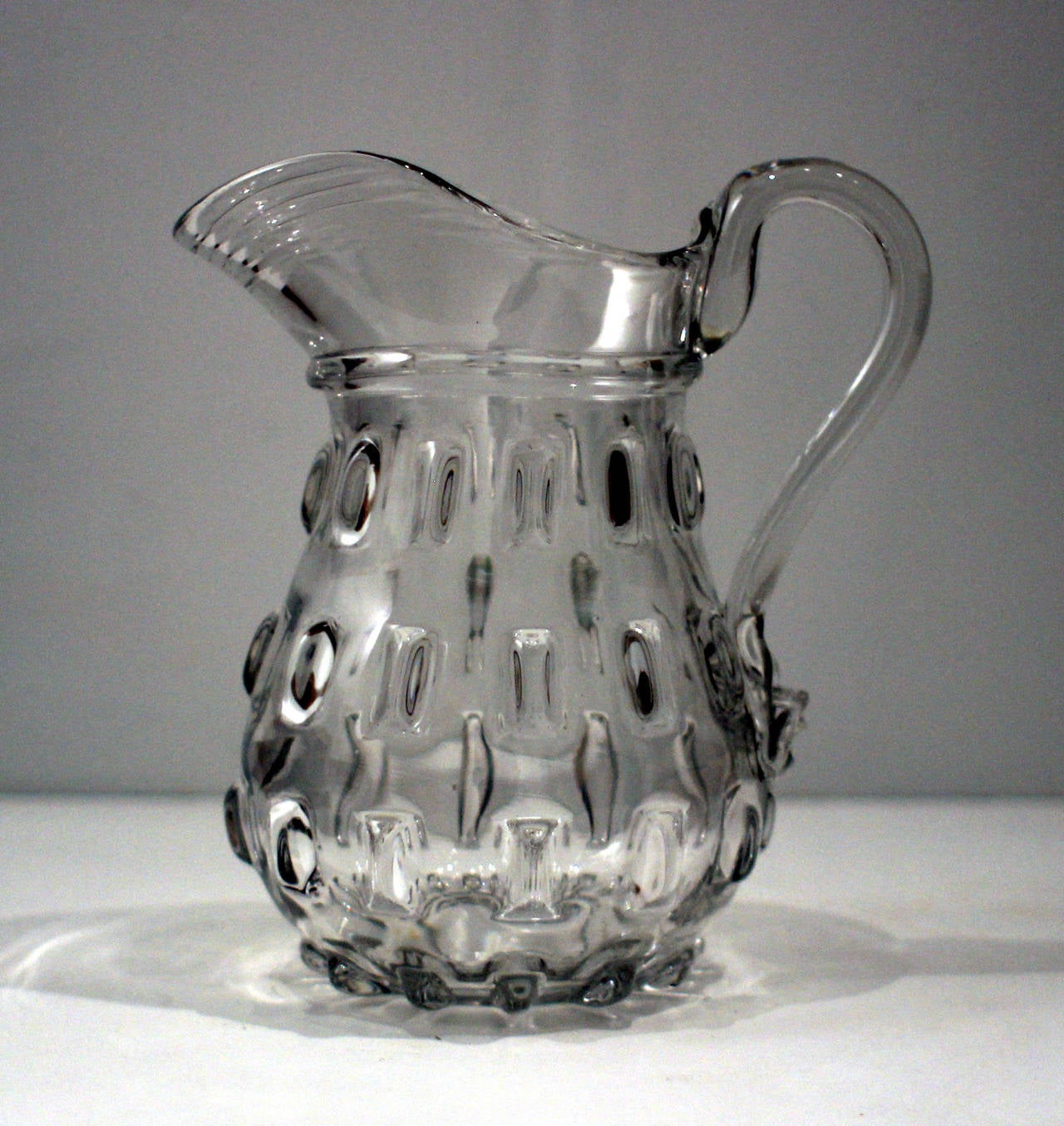 Handsome handblown glass pitcher in the cleat pattern, with applied handle and rippled rim; probably Pittsburgh, circa 1850. Fine and heavy example.