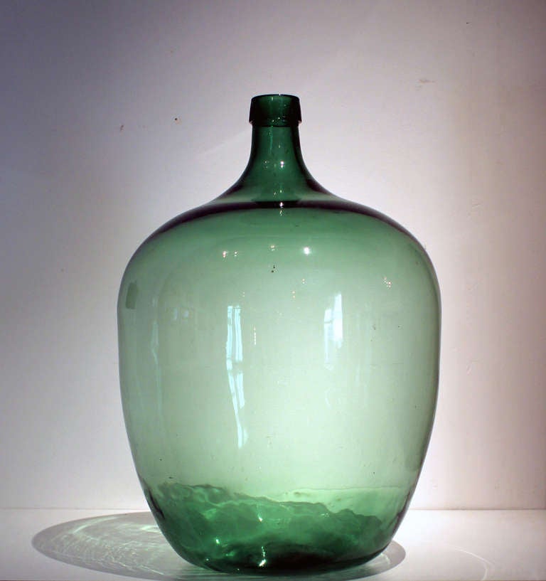 Extremely large and fine, deep green blown glass demijohn bottle; American, circa 1870. Excellent condition.