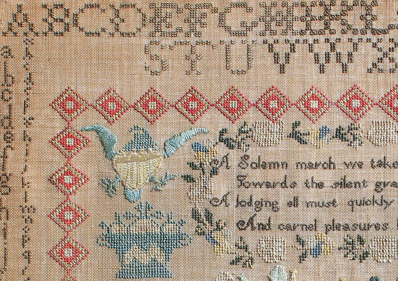 An outstanding sampler featuring an unusual and handsome house and a fine graphic diamond-format border, this was made by Mary Vought Throckmorton of Freehold, New Jersey. Flanking the wreathed verse are baskets and birds, importantly one is an