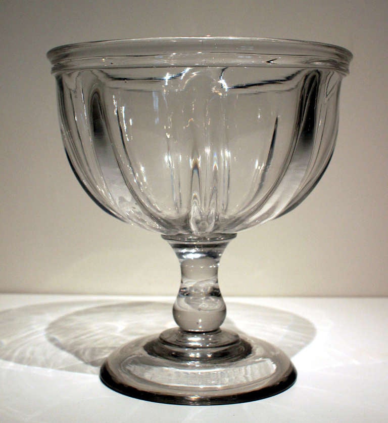 Large, deep pillar-molded blown glass compote with applied base and folded rim. Probably Pittsburgh, Pennsylvania in origin, circa 1850. Very heavy, with strong, fluid lines. 