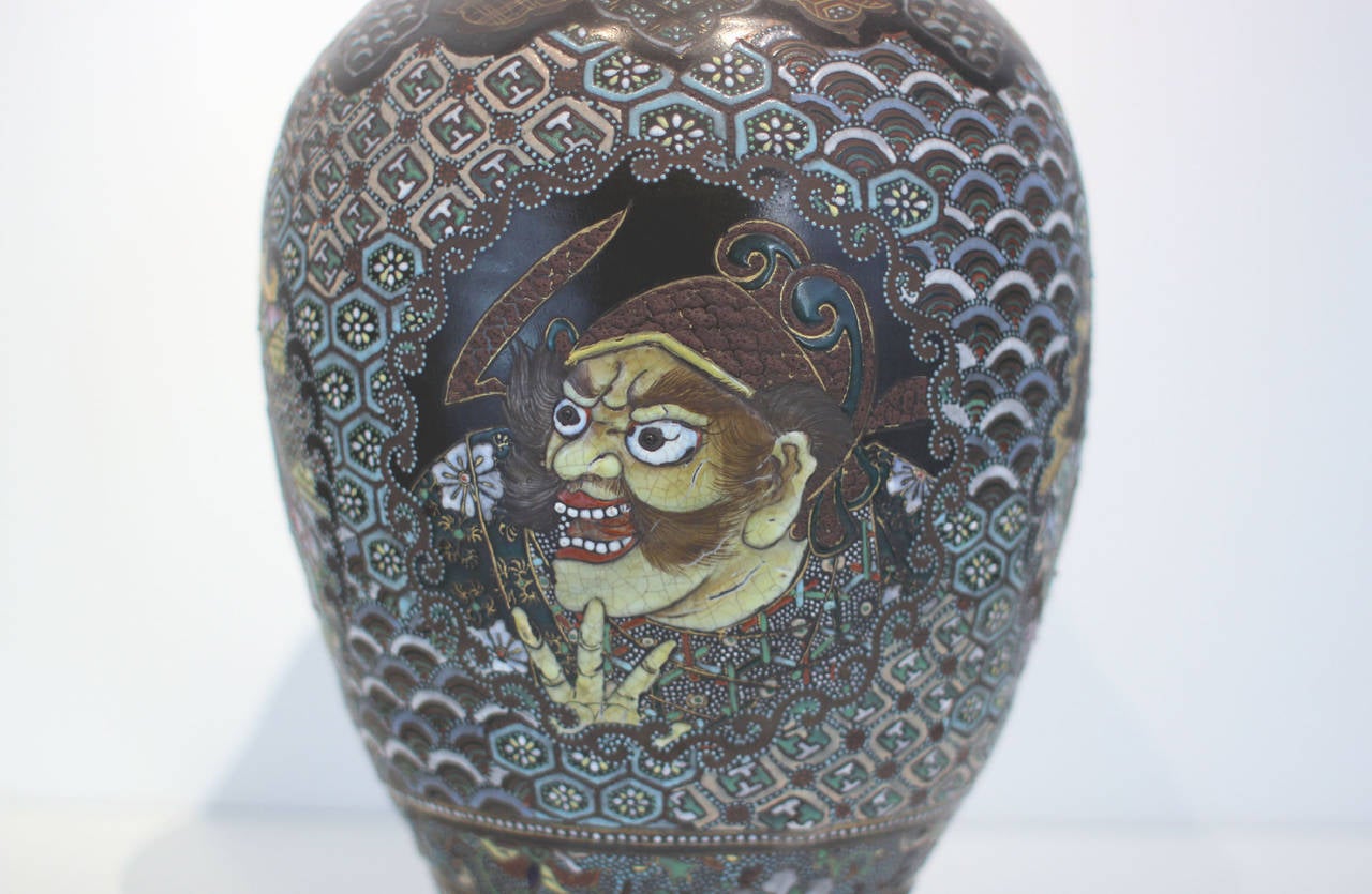 Large vase / urn, thickly enameled earthenware, with dramatic, theatrical faces, fully decorated; unglazed interior. Japanese, circa 1900. Makes a very strong statement.