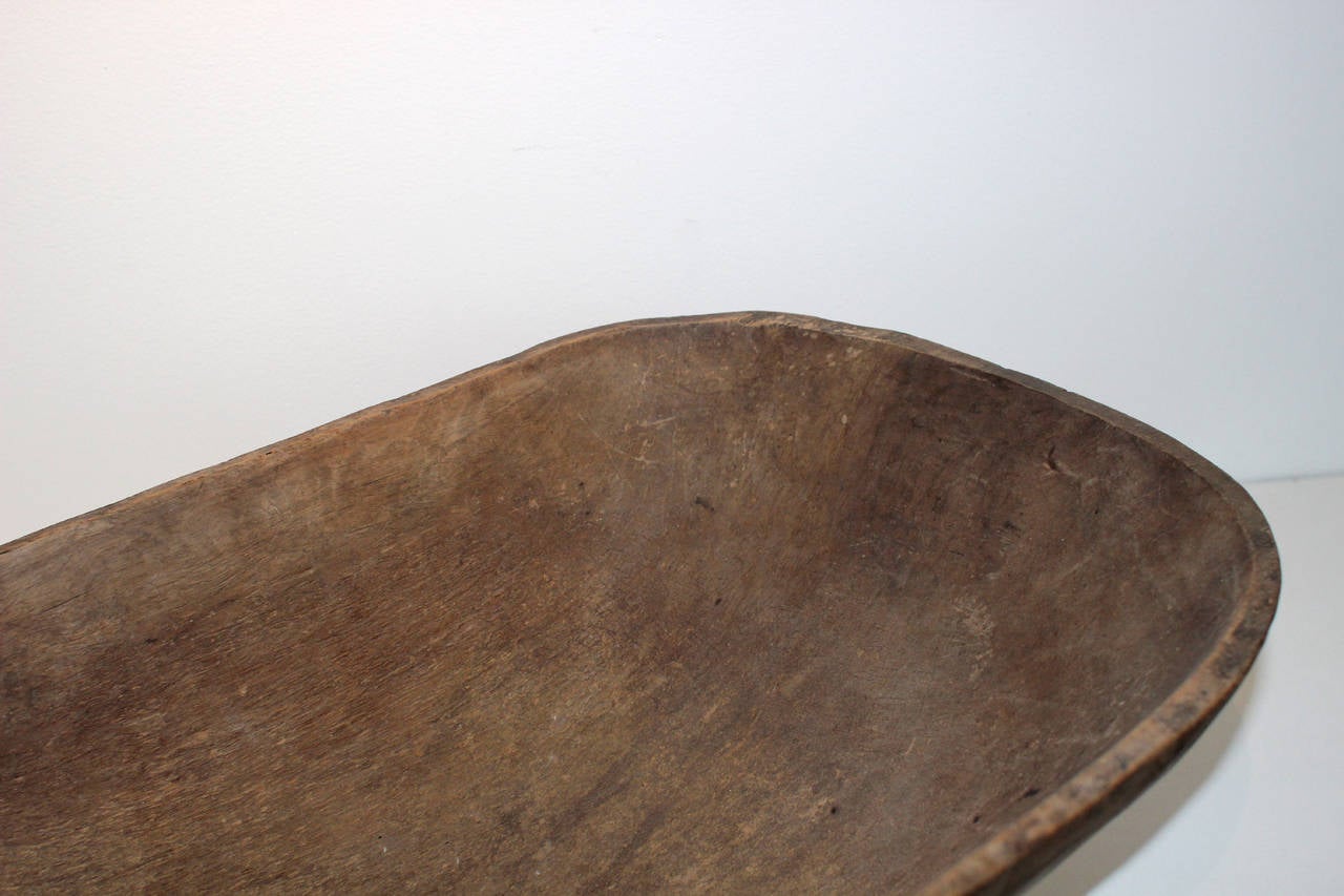 Large carved trencher, deep, with well-handled exterior surface; 19th century, American. Great as a large serving bowl or for a centerpiece on a large dining table. Wonderful patina.