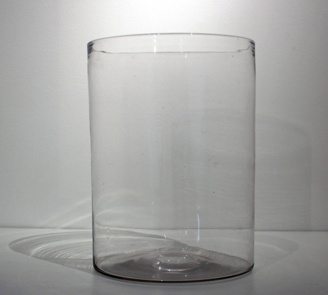 Outstanding form this is a fine, clear blown glass cylindrical vessel with equally clean pontil. Excellent versatile form of thin, evenly blown glass, American, mid-19th century.