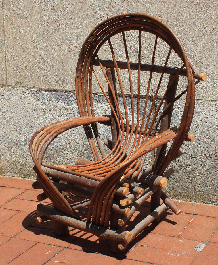 Child's chair formed from twigs, with sweeping arms and hoop back, American, circa 1950.