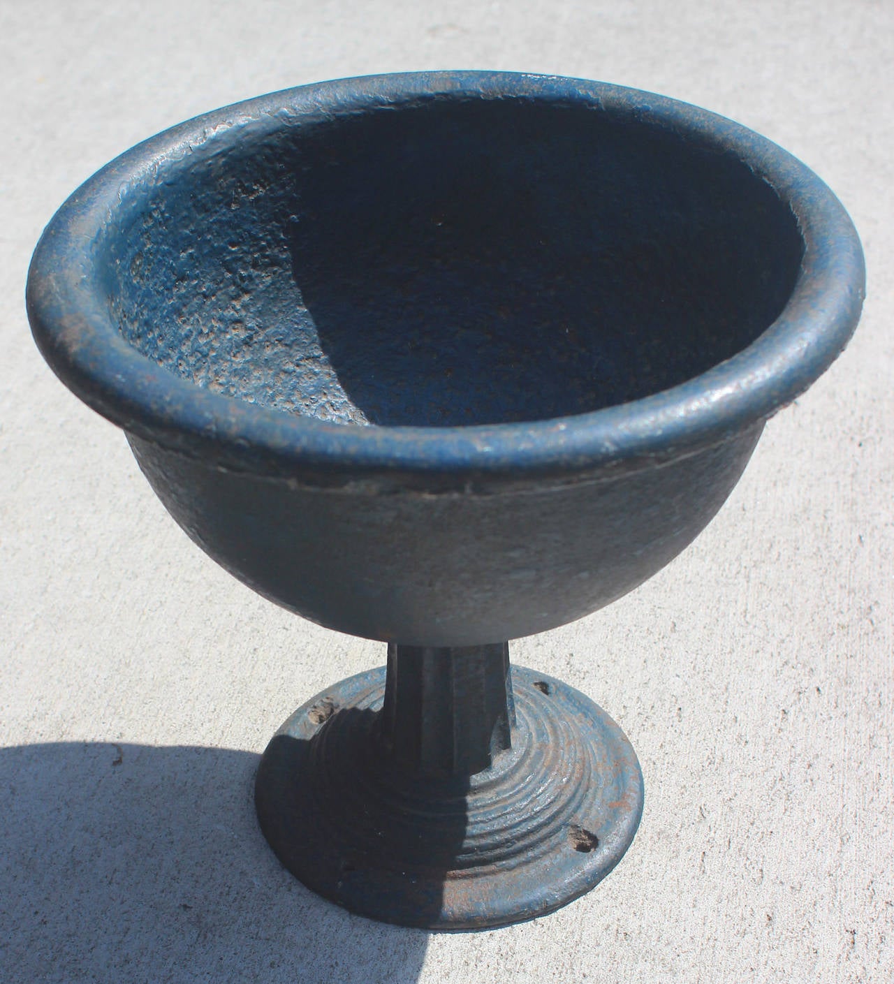A handsome cast iron compote on a fluted center column and in wonderful, original blue paint. The bowl is beautifully proportioned and has a nice rolled edge; there is a drainage hole so that it can be planted. The base is nicely detailed as well