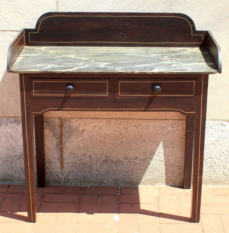 Painted server with faux marble painted top and grain painted body with sharp yellow line detail. Paint is all original. Two dovetailed drawers and sturdy straight legs. American, probably New England, circa 1830.
