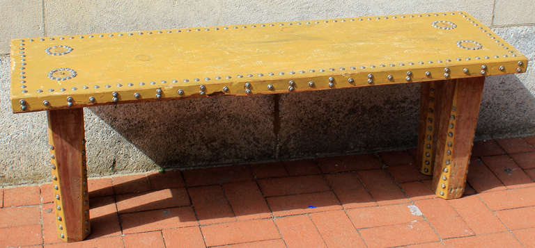 Solid painted bench with brass tack decoration. Original paint, nice oxidation to the tacks, angled legs with visible raw wood. Early 20th century.