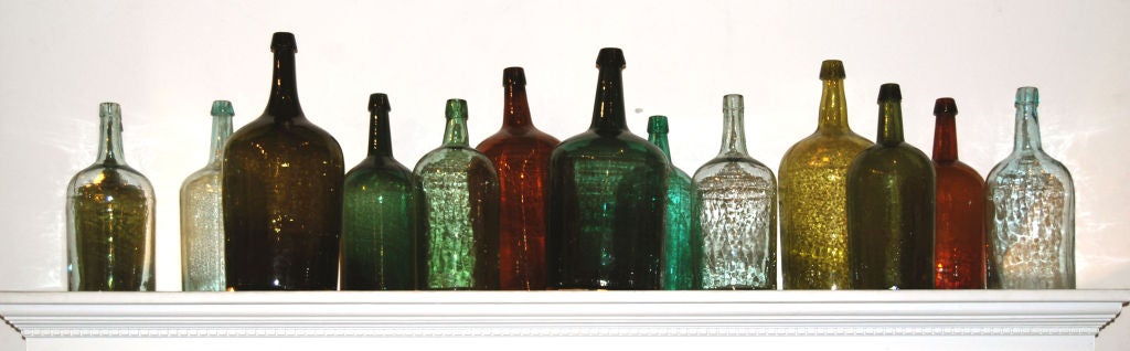 Wonderful collection of 14 colored glass bottles, all hand blown and molded, in various shades of green, blue, aqua and amber; all are American, circa 1880. Priced for the whole collection, but could be sold individually, prices would vary with