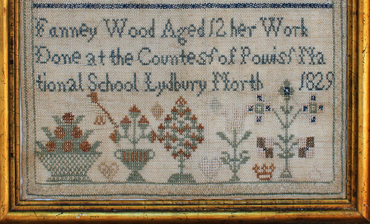 Nicely stitched sampler made at the Countess of Powiss National School located in the village of Lydbury North, in Shropshire. The maker, Fanney Wood, was born in the same village and christened there on September 7, 1817. A large alphabet and a