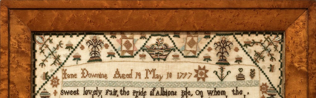 Jane Downing stitched this large and exceptional polychrome sampler in 1797 at the age of 14. It features excellent needlework renderings of pictorial images in the splendid borders and bands; with striped baskets, geometric stars and urns rich with