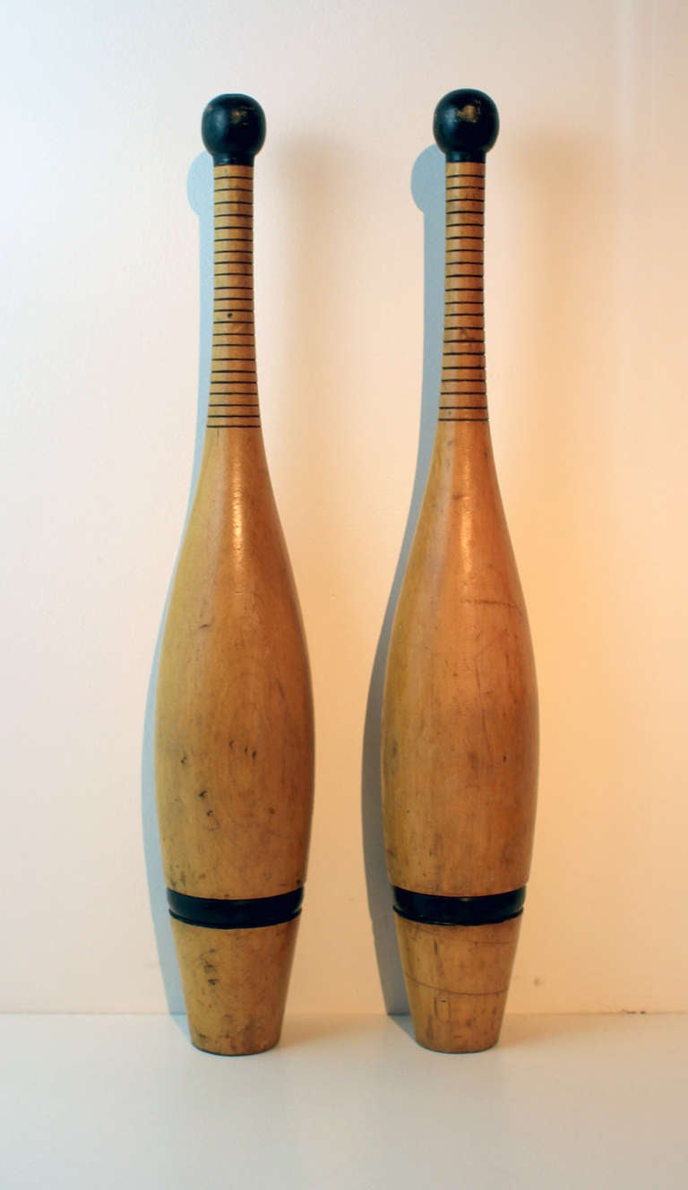 Very good pair of turned Indian clubs with original paint decoration and crisp turned detail. American, late 19th century. Nice lines.