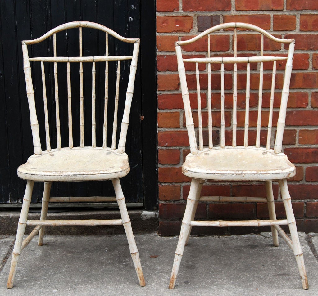 Outstanding pair of Windsor side chairs in original white paint, attributed to James Chapman Tuttle, Salem, Massachusetts, circa 1810, with distinctive characteristics of his workshop. Bamboo-style turnings and high arched square back add fine