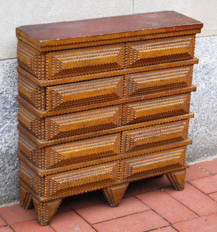 An excellent tramp art chest in its original ochre painted finish, with 8 drawers and an unusual proportion. The drawers are made of cigar boxes with original labels from Pennsylvania, Ohio and Milwaukee, Wisconson; and because of the dimensions of