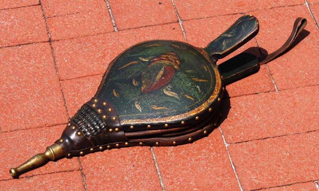 American folk painted turtleback bellows with original paint and decoration and restored leather and mechanics; American, circa 1840. Good working condition.