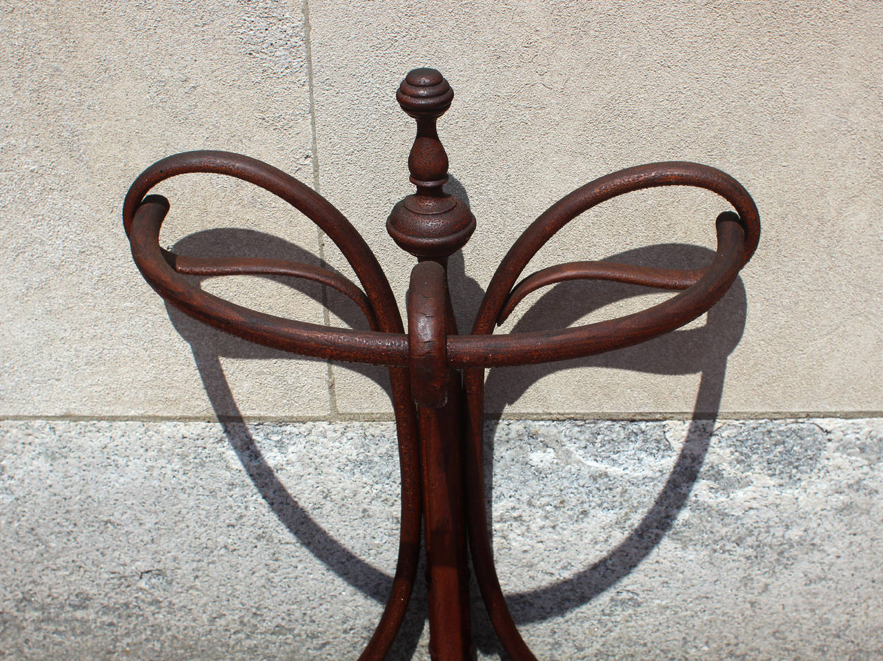 Very good bentwood umbrella stand with handsome swooping features, turnings and excellent patina; late 19th century. Great upright pilaster. Original tin tray.