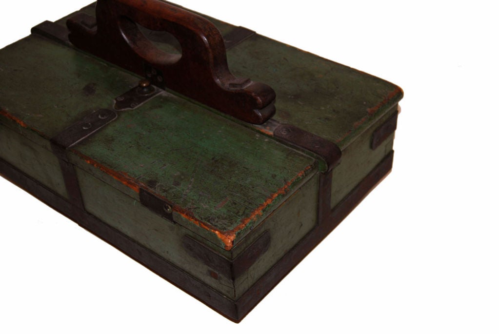 Unusual box with two hinged lids, five compartments, four feet and one finely carved mahogany handle for carrying. Iron straps and hardware add appealing detail and function, spring-operated hasp closure on each lid. All original.