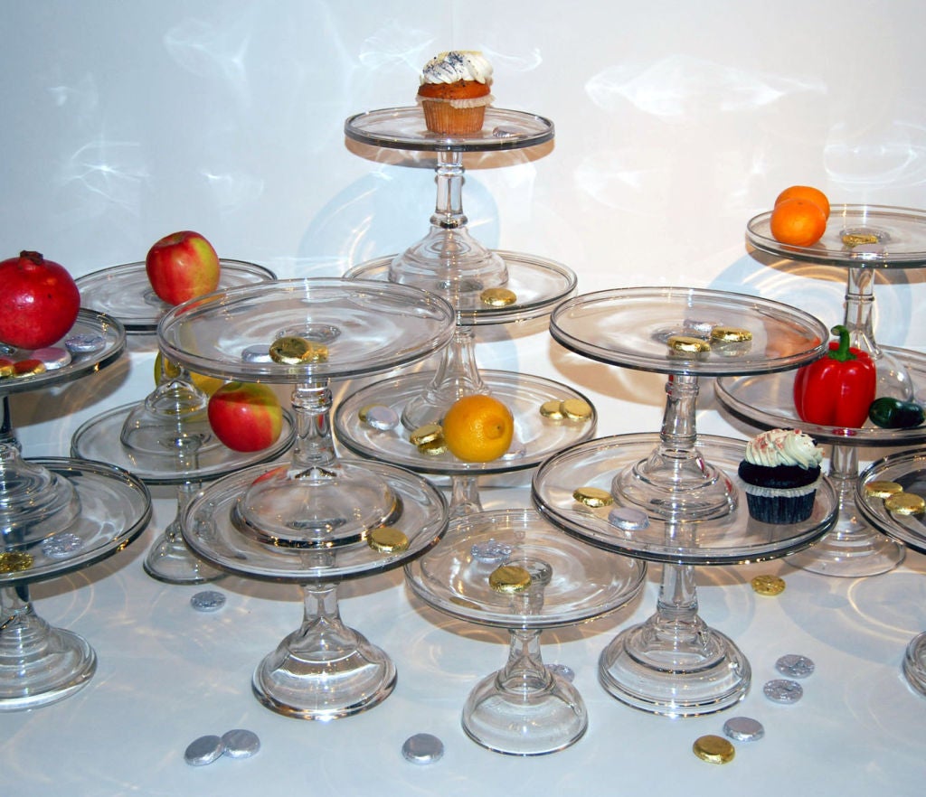 We have 15 variously sized colorless pressed glass pedestal cake stands or tazzas, to be sold individually. Small, medium and large, each could hold a 6-10