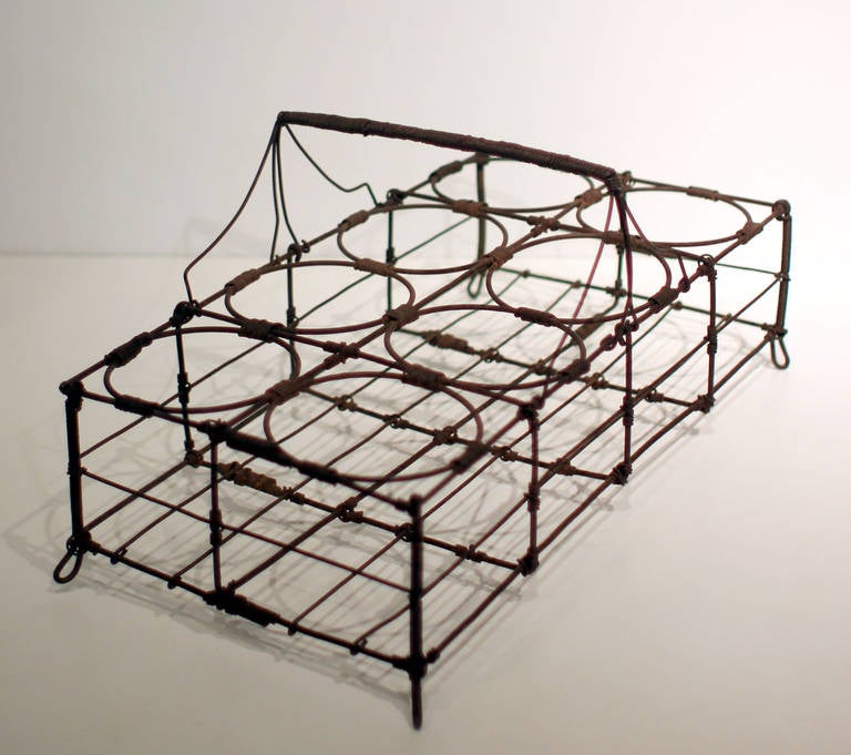 Wire was used for a variety of purposes - this carrier was meant to hold eight glasses or tumblers. Excellent patina, French, late 19th century. 