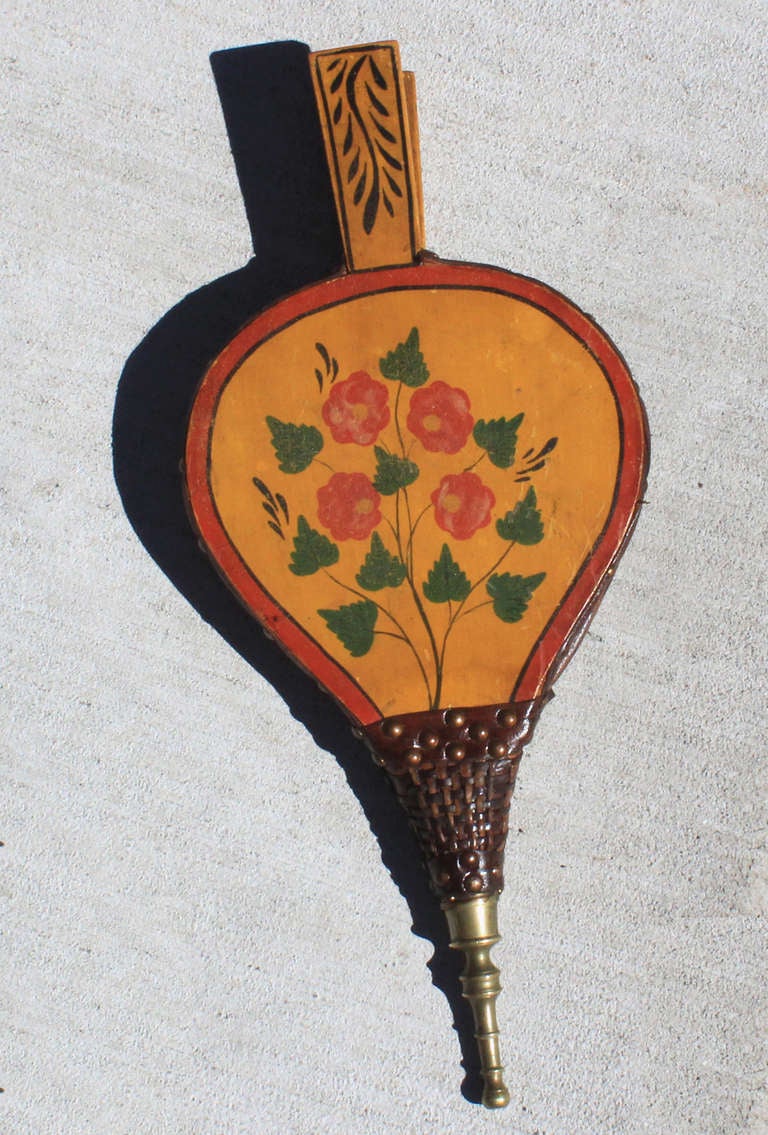 American folk painted bellows with all original paint and flower on leafy branch decoration, on a wonderful ochre field; leather and mechanics have been restored and its now in good working condition; American, circa 1840.
