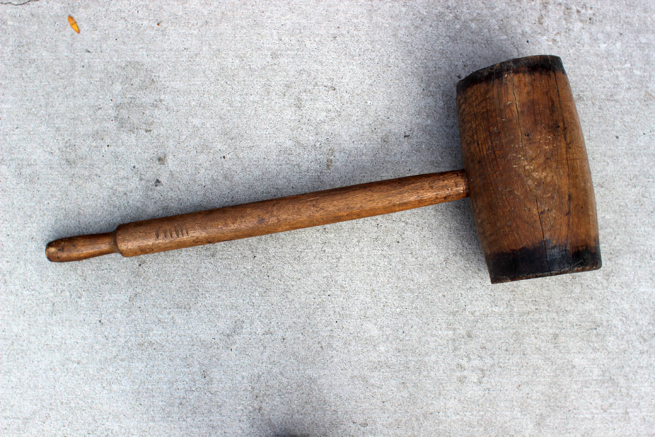 Very good wooden carnival mallet with painted bands on the head; probably American. Used for the high striker or strongman game at carnivals and circuses, early 20th century.