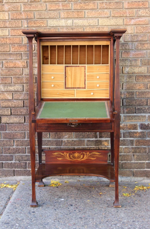 Arts & Crafts desk with outstanding inlay and penwork. Excellent lines, blond wood interior and green felt writing surface. All original, English, circa 1900. The back has a small shipping label. May have been sold by Liberty of London.
