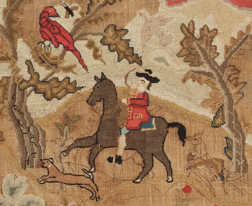 This praiseworthy example of Boston needlework, partially worked and partially unfinished, features the classic bucolic scenes of gentlefolk in settings with flora and fauna. A gentleman on horseback and his trusty little dog chase a deer beneath a