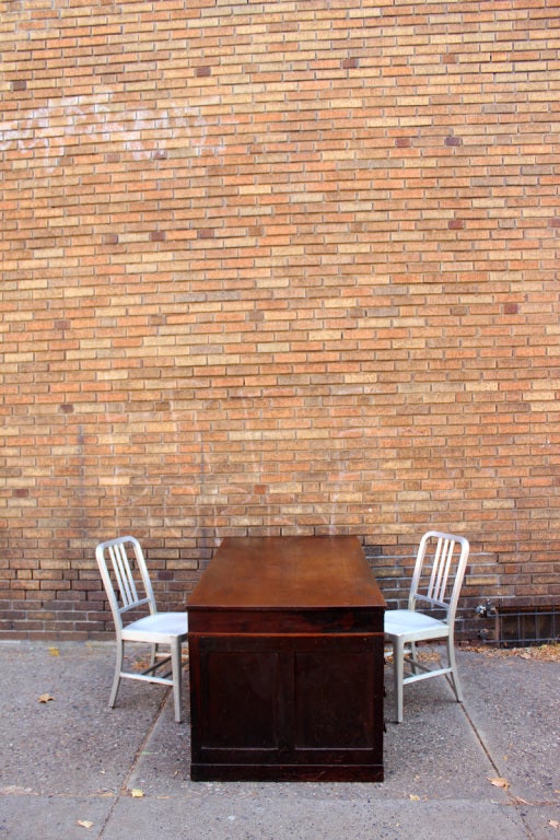 Excellent and highly practical walnut partners desk with 11 deep drawers on one side and 2 shallow, divided cupboards on the other, and four panel sides. Nice dovetail construction throughout with fine cabinetwork; it was made in three parts; and