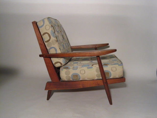 The classic arm chair form by Nakashima made of Walnut. Chair has just the right amount of recline to be very comfortable without taking up a large amount of floor space. A well thought out design form.