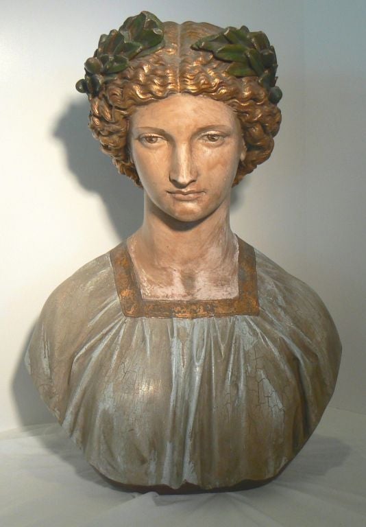 A somber yet beautiful face to view in this classically posed bust with Romanesque laurel wreath. Signed 