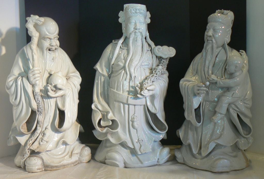 A magnificent trio of Chinese figures of 18th/19th century origin.  All three figures of blanc de chine dehua porcelain are in superb condition for their age and make an unsparing impression of good will assembled together.  Excellent molding of
