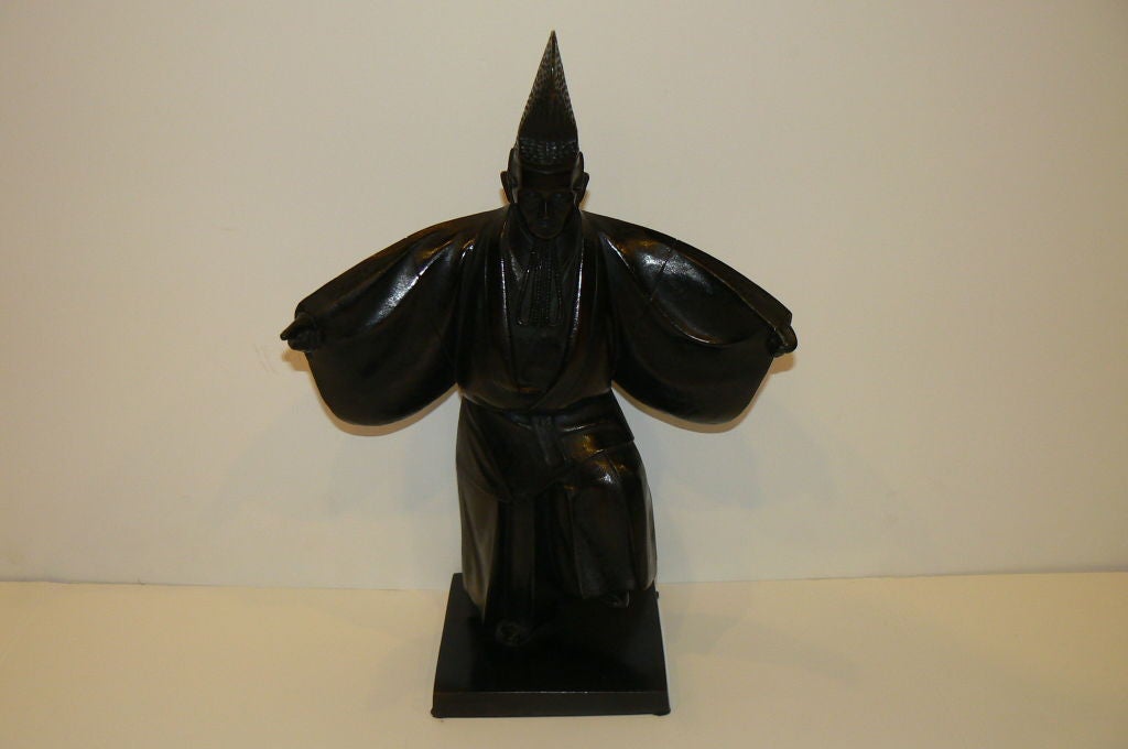 Bronze Sculpture of a Sumo Referee with moulded plinth. The figure is dressed in formal attire performing the opening rites of Sumo. High quality rendering which combines the emodernist influence of simplifying the form of his costume. Original