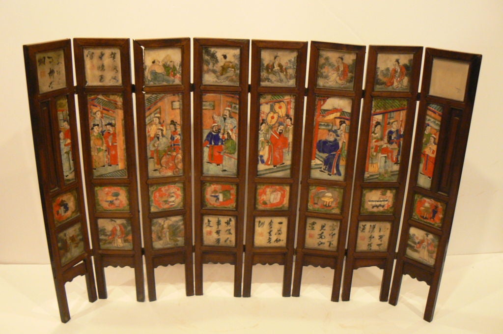 Chinese. A Small Eight Panel Folding Screen Inset with Painted Marbel Panels. The marbel plaques floating with wood frames, painted on both sides with calligraphy, landscape, figure scenes and auspicious objects. The wood is called Hong-mu (red