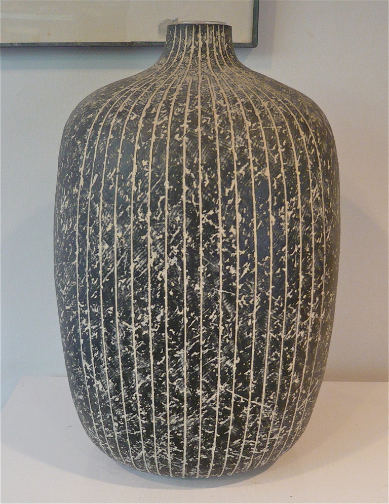 
Cleveland,Ohio ceramicist Claude Conover combines two of his hand applied techniques, striping and scrafitto on this hand thrown vessel,signed and  titled 
