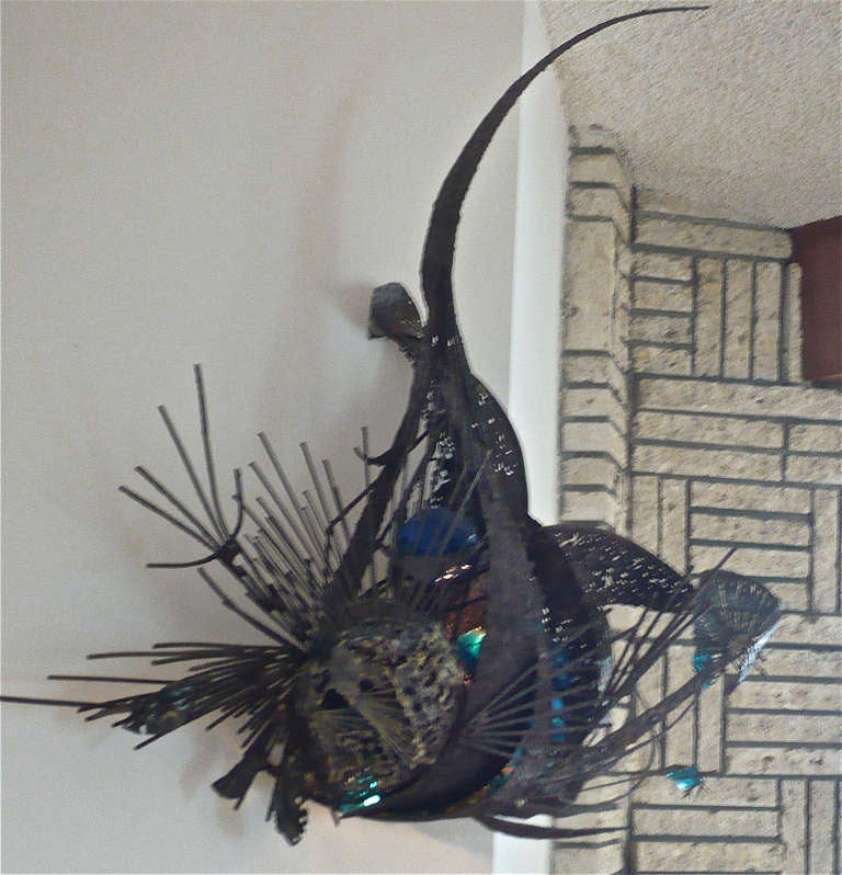 Designed specifically for this modern house  to wrap around the corner of the wall,over the fireplace.Brass welded with blue glass inserted in the sculpture and back lit option.Can be adapted to hang directly on one wall surface.
Signed but not