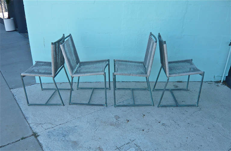 Set of four (4) outdoor dining chairs, Series 1 Walter Lamb pre-MOMA show of 1952 designed for Brown Jordan in 1946.
Tubular bronze frames with rope seats and backs. Nice patina to the bronze with some discoloration to the rope from being
