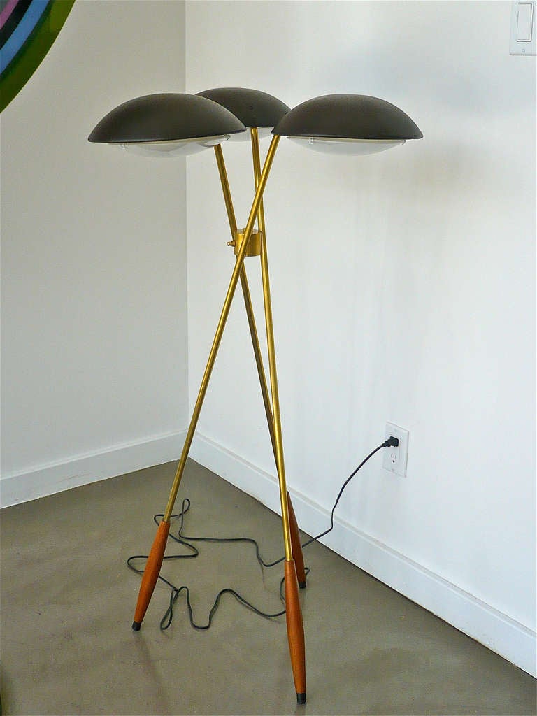 Designed by Gerald Thurston for Lightolier. Tripod based floor lamp with three dark brown lacquered metal shades with white plastic diffusers. The legs are made out of brass and have wooden accents.