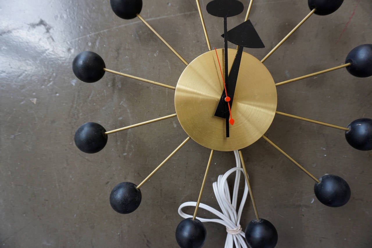 Clock designed by George Nelson and Associates for the Howard Miller Clock Co.
Part of a collection of vintage Nelson clocks Studio one 11 will be offering on 1stdibs.
Brass body with painted wooden balls.
Rewired and working perfectly.