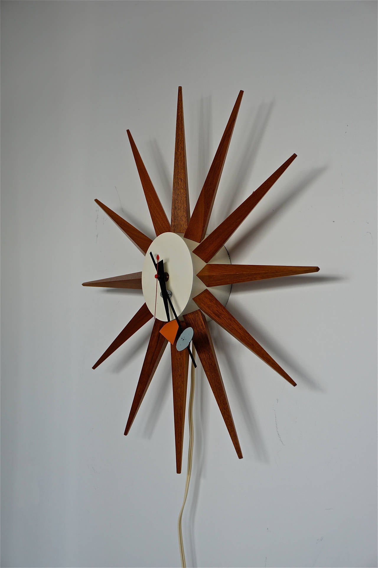 Designed by George Nelson and Associates for the Howard Miller Clock Co.
Part of a collection of vintage Nelson clocks studio one 11 will be offering on 1stdibs.
Walnut spokes, painted metal body, enameled metal hands.
Rewired and runs perfectly.