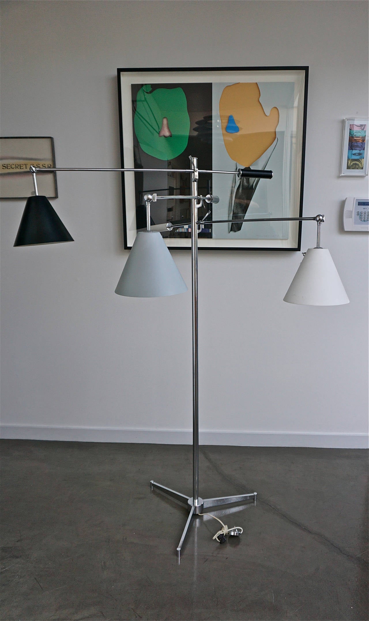 Black, gray and white adjustable shades on adjustable arms with similar painted metal counterweights, each shade has it's own on/off switch. Chromed metal pole measures 62